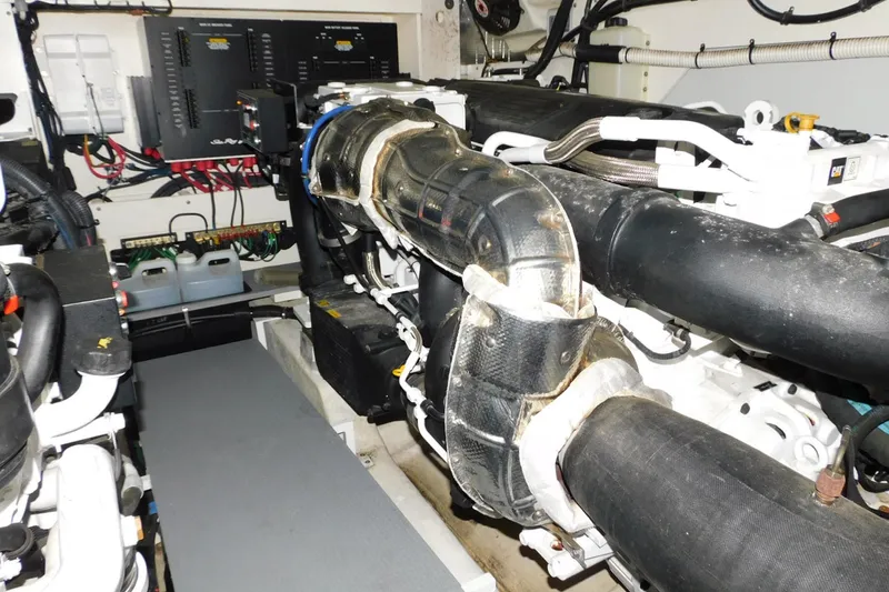 Slide: The Image of Engine room of 2019 Sea Ray L550 yacht, showcasing complex machinery and wiring. - 30