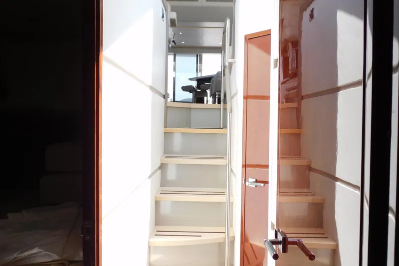 Slide: The Image of Interior view of 2019 Sea Ray L550 yacht, featuring sleek stairs and modern design. - 34