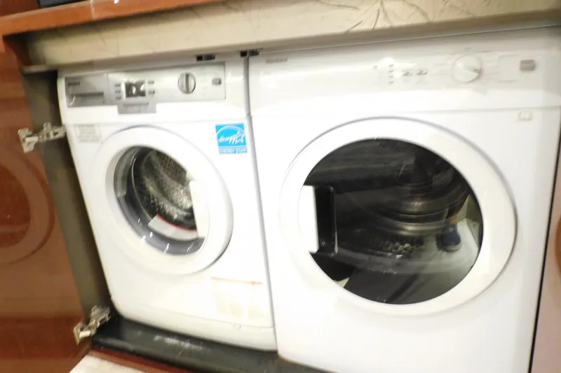 Slide: The Image of Laundry appliances inside a 2019 Sea Ray L550 yacht cabinet. - 38