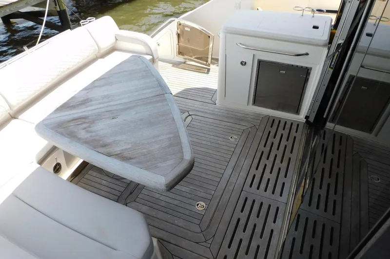 Slide: The Image of Luxurious 2019 Sea Ray L550 yacht deck with elegant seating and wooden table. - 4
