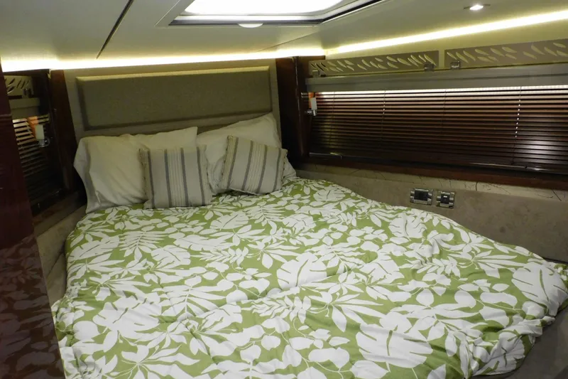 Slide: The Image of Luxurious 2019 Sea Ray L550 yacht bedroom with floral bedding and elegant lighting. - 44