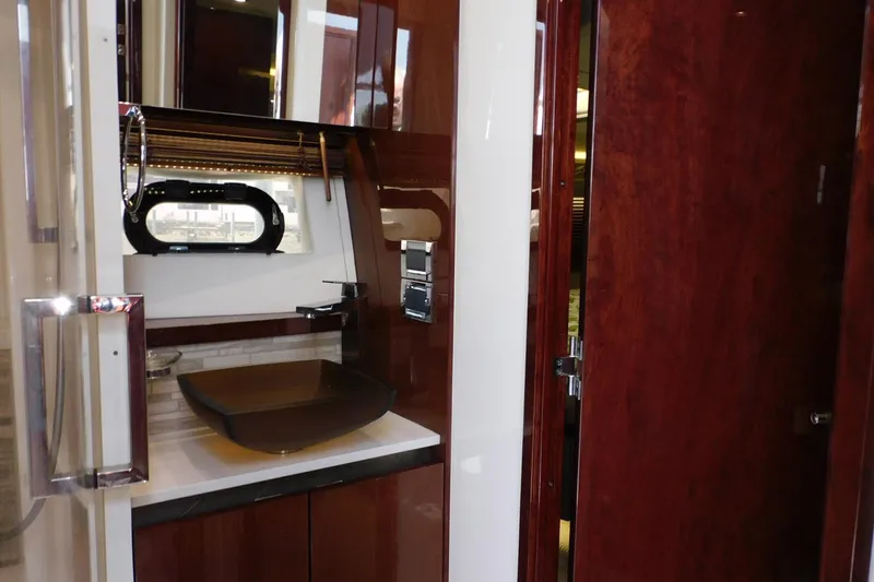 Slide: The Image of Luxurious 2019 Sea Ray L550 yacht bathroom with modern sink and elegant wood finishes. - 45