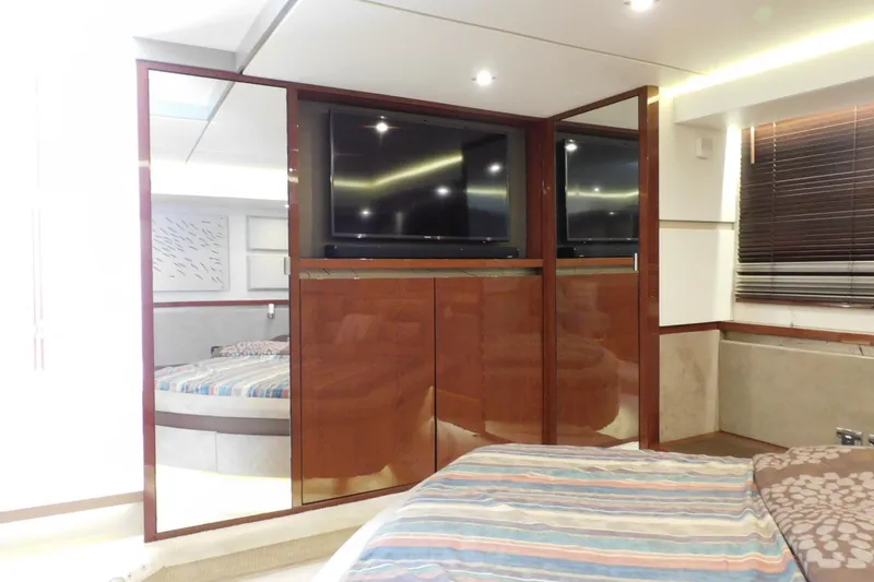 Slide: The Image of Luxurious interior of 2019 Sea Ray L550 yacht with modern wood paneling and TV. - 47