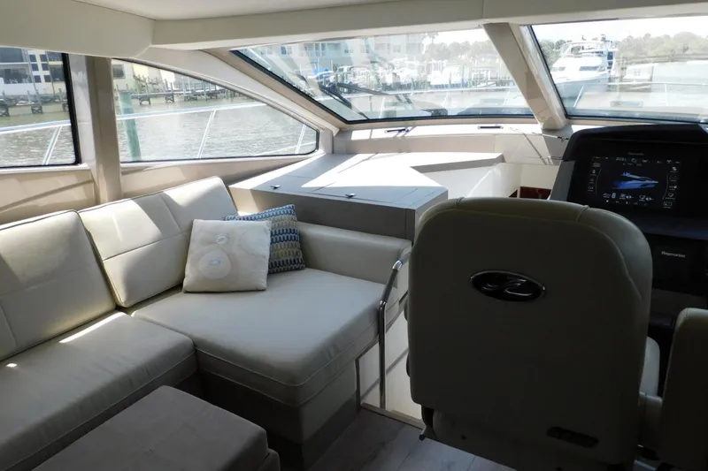 Slide: The Image of Luxurious interior of 2019 Sea Ray L550 yacht with plush seating and modern helm. - 49