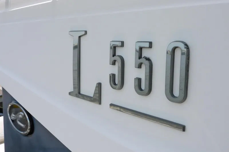 Slide: The Image of 2019 Sea Ray L550 yacht model emblem on white hull. - 5