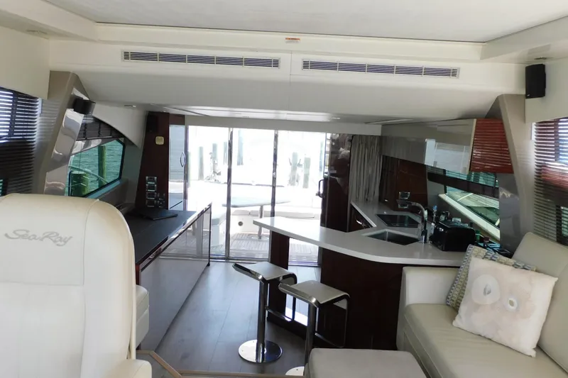 Slide: The Image of Luxurious interior of 2019 Sea Ray L550 yacht with modern kitchen and seating area. - 50