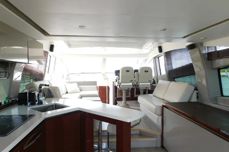 Slide: The Image of Luxurious interior of 2019 Sea Ray L550 yacht with modern seating and kitchen area. - 53