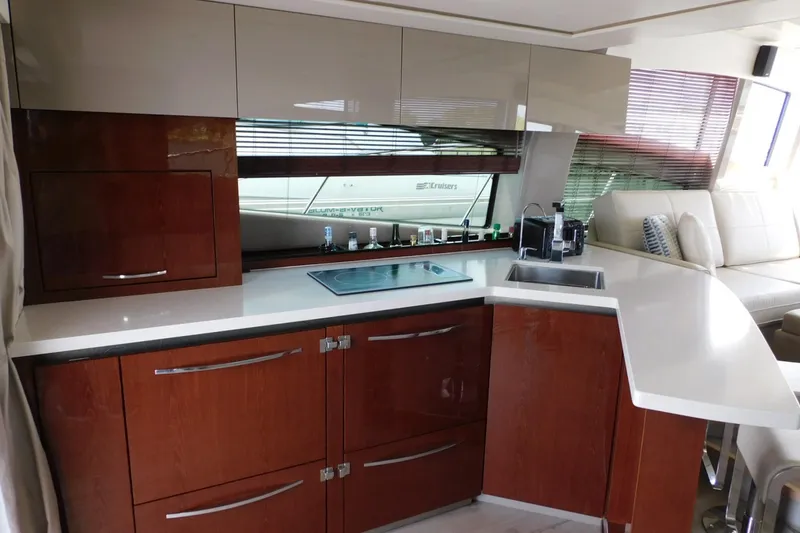 Slide: The Image of Luxurious 2019 Sea Ray L550 yacht kitchen with modern cabinetry and sleek countertops. - 54