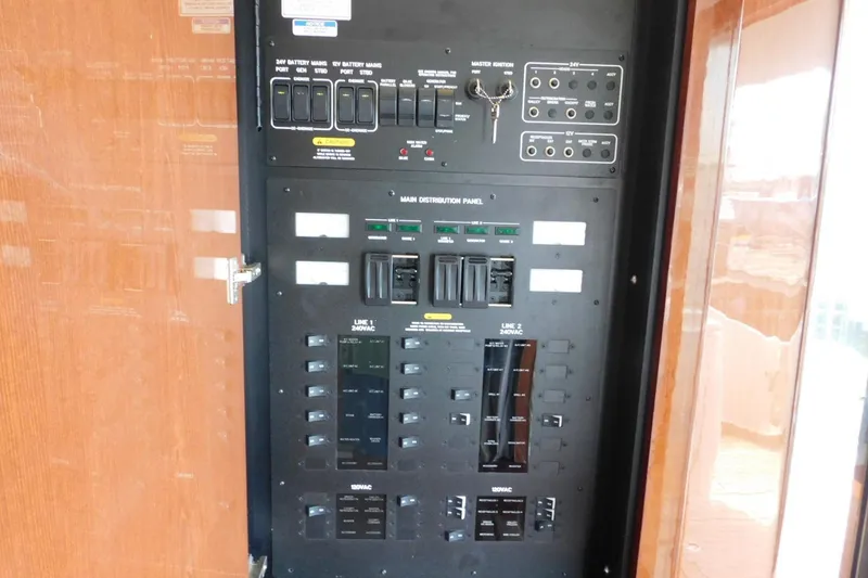 Slide: The Image of Electrical control panel inside a 2019 Sea Ray L550 yacht, featuring various switches and indicators. - 55