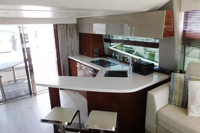 Slide: The Image of Luxurious interior of 2019 Sea Ray L550 yacht featuring modern kitchen and seating area. - 58