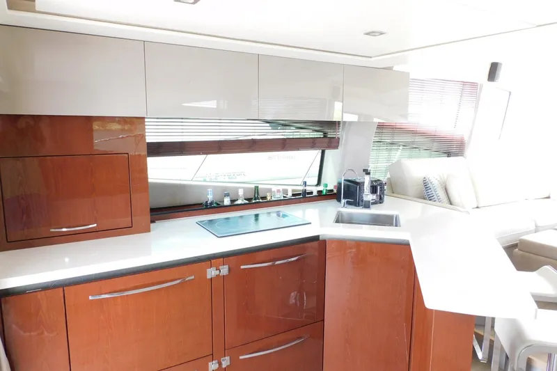 Slide: The Image of Luxurious kitchen interior of 2019 Sea Ray L550 yacht with modern cabinetry and appliances. - 59