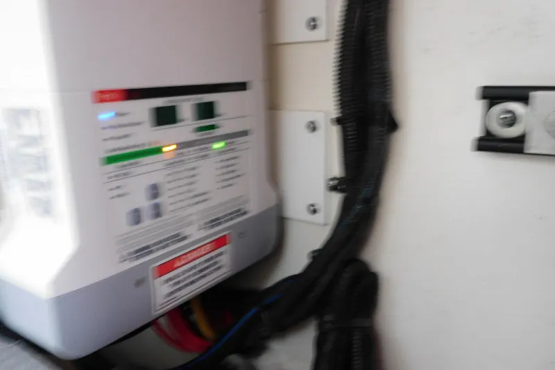 Slide: The Image of Electrical panel inside a 2019 Sea Ray L550 yacht, featuring wiring and control indicators. - 63