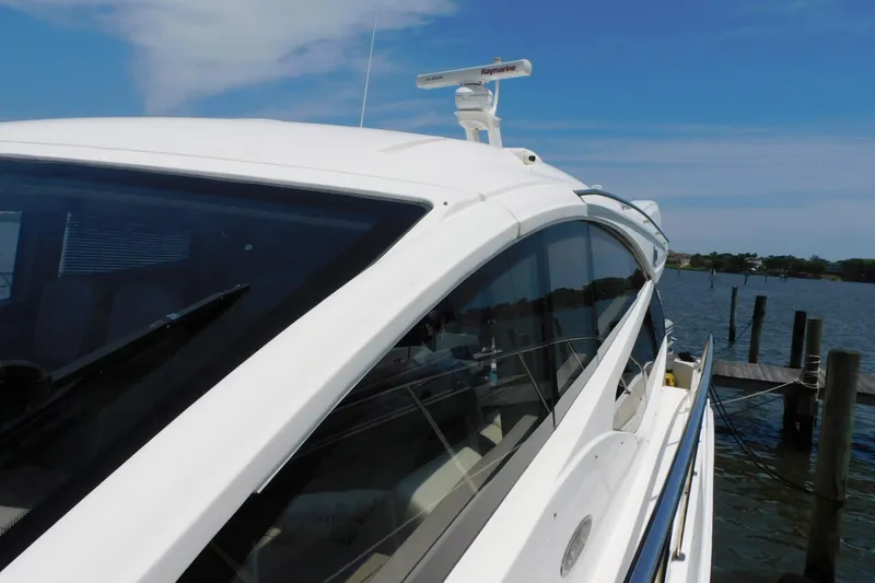 Slide: The Image of 2019 Sea Ray L550 yacht docked by the water on a sunny day. - 7