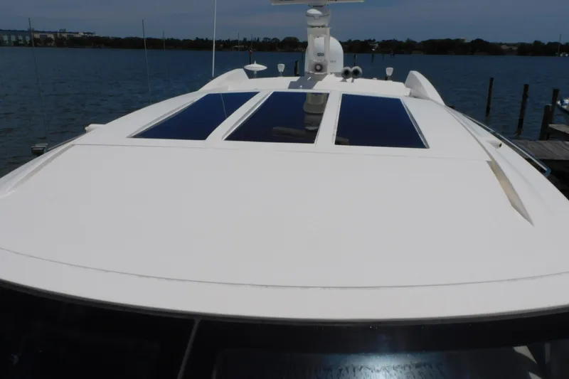 Slide: The Image of 2019 Sea Ray L550 yacht with sleek design and panoramic windows on calm water. - 8