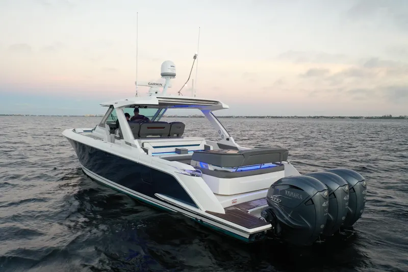 Slide: The Image of 2020 Tiara Yachts 43 LS on water at sunset, featuring triple Yamaha engines. - 1