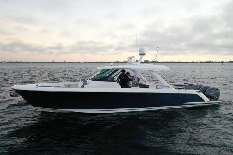 Slide: The Image of 2020 Tiara Yachts 43 LS cruising on open water under cloudy skies. - 10