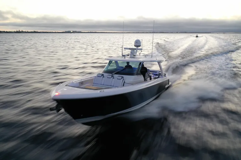 Slide: The Image of 2020 Tiara Yachts 43 LS cruising swiftly on open water at sunset. - 11