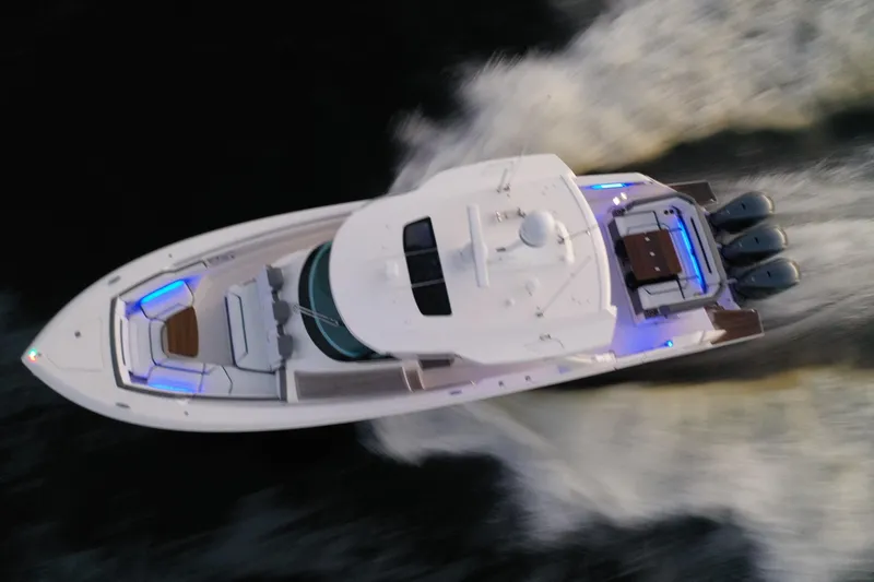 Slide: The Image of Aerial view of 2020 Tiara Yachts 43 LS cruising on water, showcasing sleek design and powerful engines. - 13