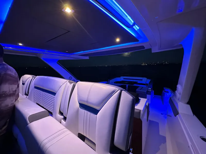 Slide: The Image of 2020 Tiara Yachts 43 LS interior with blue ambient lighting at night. - 15