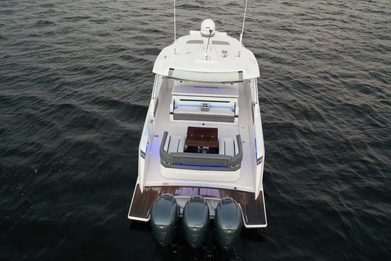 Slide: The Image of 2020 Tiara Yachts 43 LS on water, rear view with triple engines. - 2