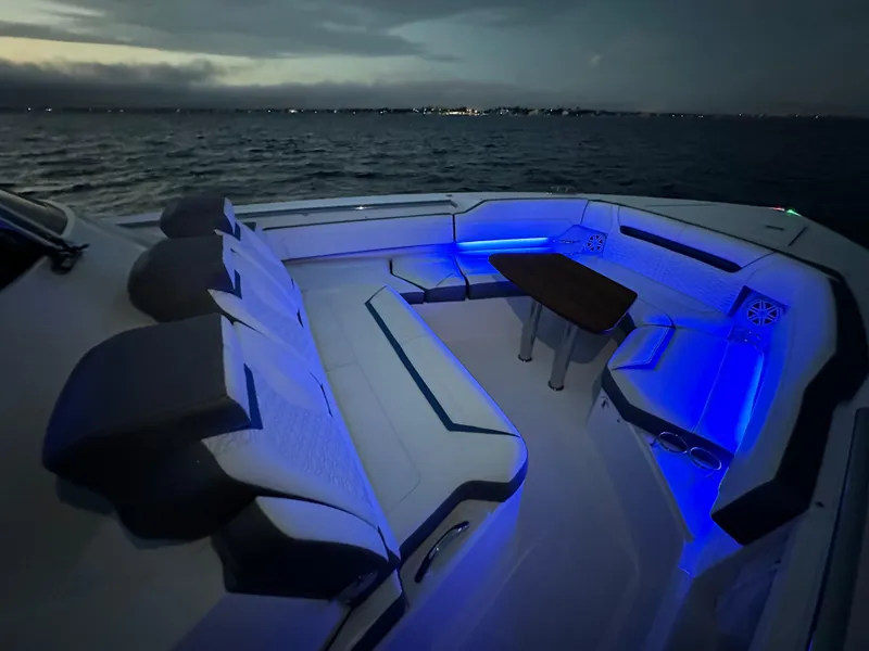 Slide: The Image of Luxurious 2020 Tiara Yachts 43 LS with blue LED-lit seating at dusk on the water. - 22