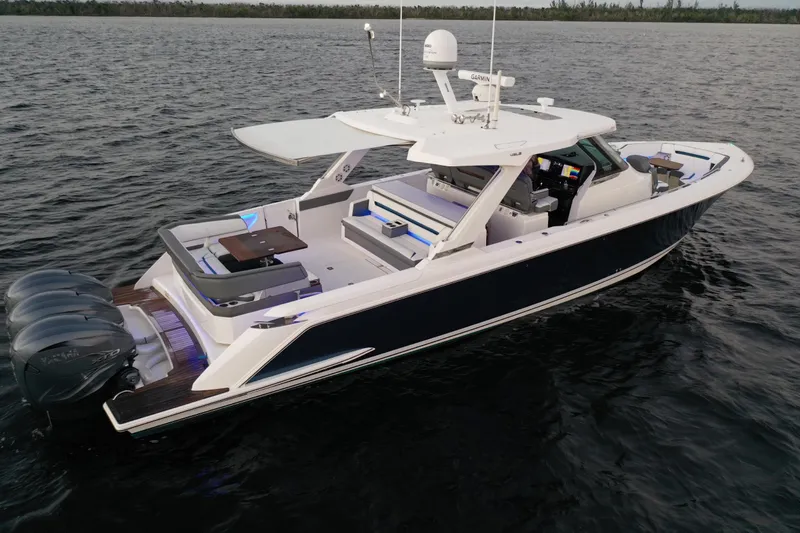 Slide: The Image of 2020 Tiara Yachts 43 LS luxury boat on open water, featuring triple Yamaha engines. - 3