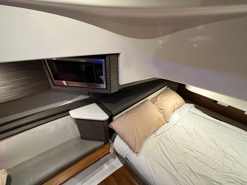 Slide: The Image of Luxurious cabin interior of 2020 Tiara Yachts 43 LS with bed and seating area. - 33