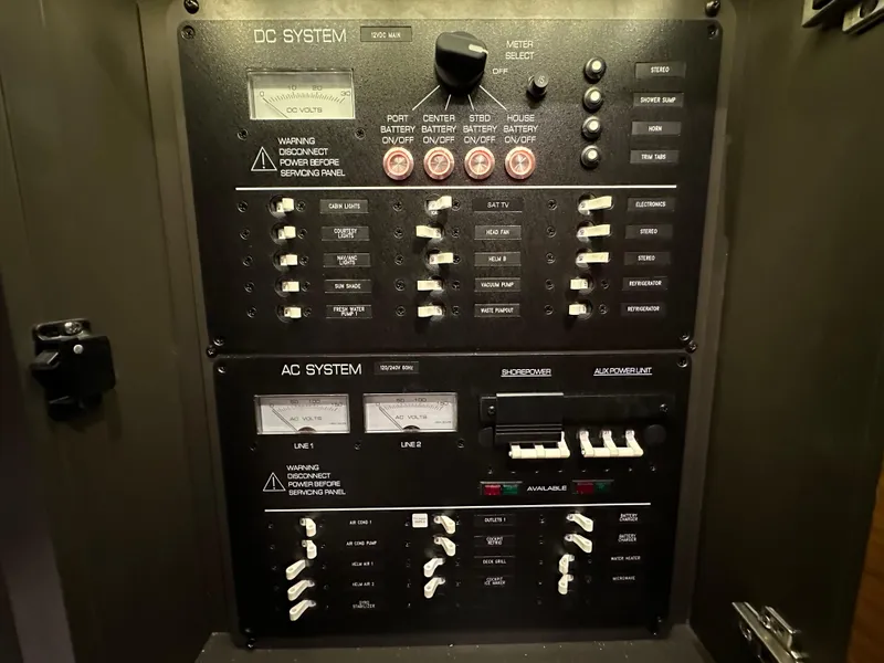 Slide: The Image of Electrical control panel on a 2020 Tiara Yachts 43 LS, featuring DC and AC systems. - 38