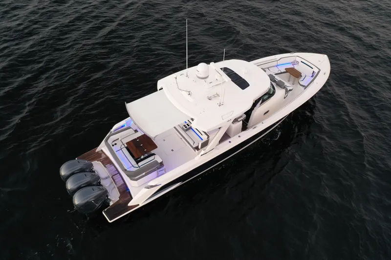 Slide: The Image of 2020 Tiara Yachts 43 LS cruising on open water, showcasing sleek design and powerful engines. - 4