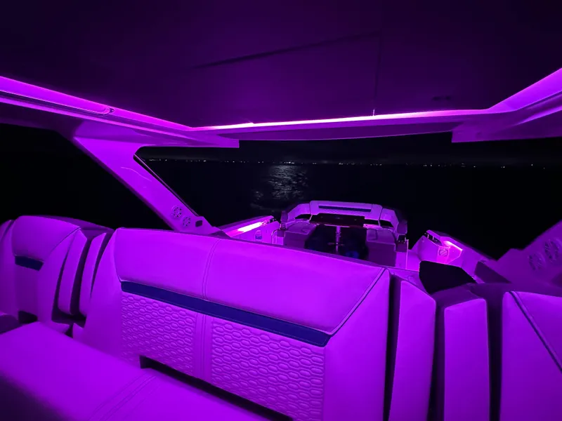 Slide: The Image of 2020 Tiara Yachts 43 LS interior with vibrant purple lighting at night. - 40