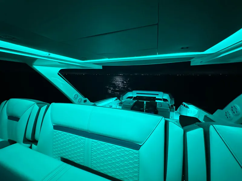 Slide: The Image of 2020 Tiara Yachts 43 LS interior with ambient teal lighting at night. - 43