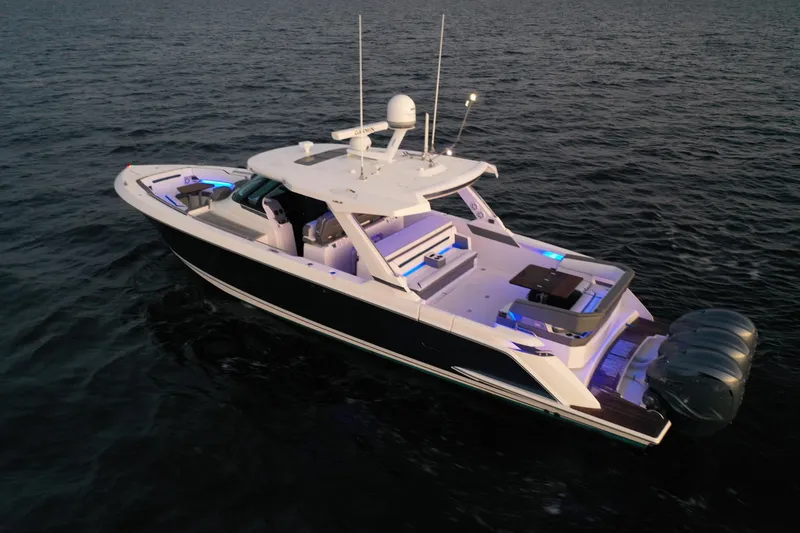 Slide: The Image of 2020 Tiara Yachts 43 LS luxury boat on open water at dusk. - 8