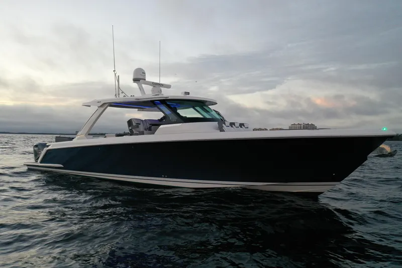 Slide: The Image of 2020 Tiara Yachts 43 LS cruising on open water at dusk. - 9