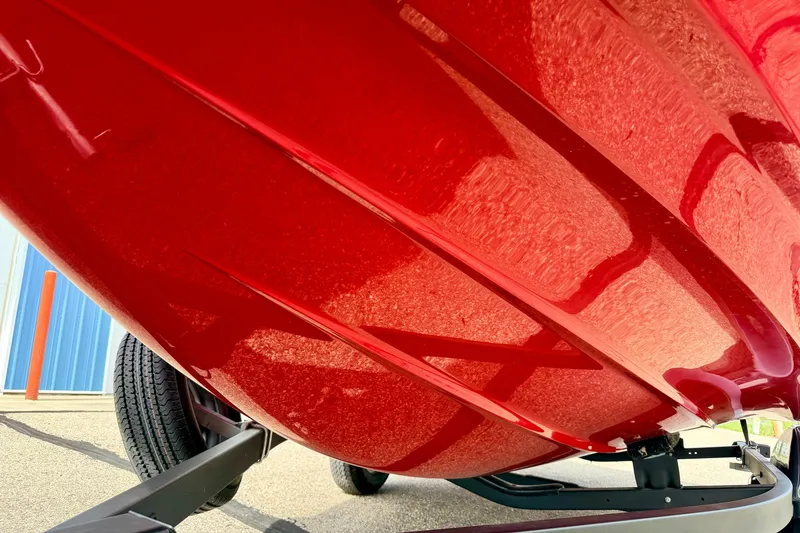 Slide: The Image of 2024 Yamaha AR195 boat hull in vibrant red, showcasing sleek design and craftsmanship. - 11