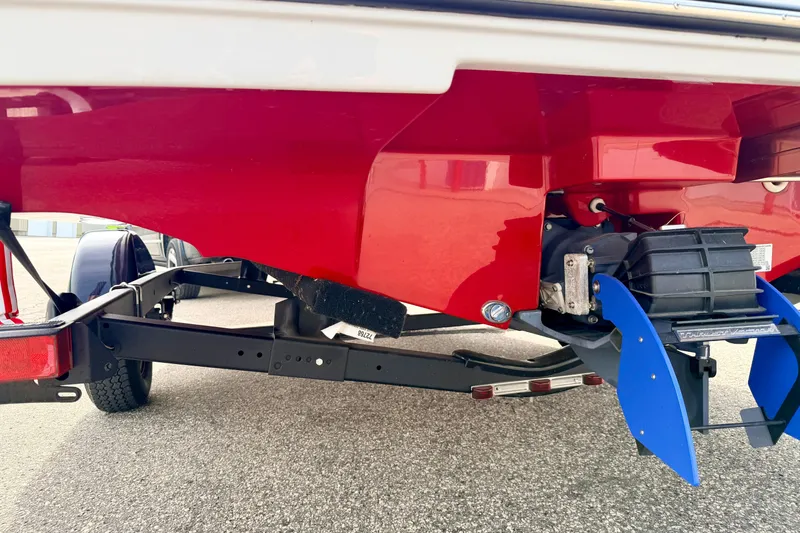 Slide: The Image of 2024 Yamaha AR195 boat trailer with red hull and blue rudder components. - 14