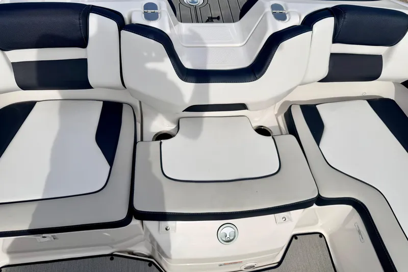 Slide: The Image of 2024 Yamaha AR195 boat interior seating with white and navy upholstery. - 21