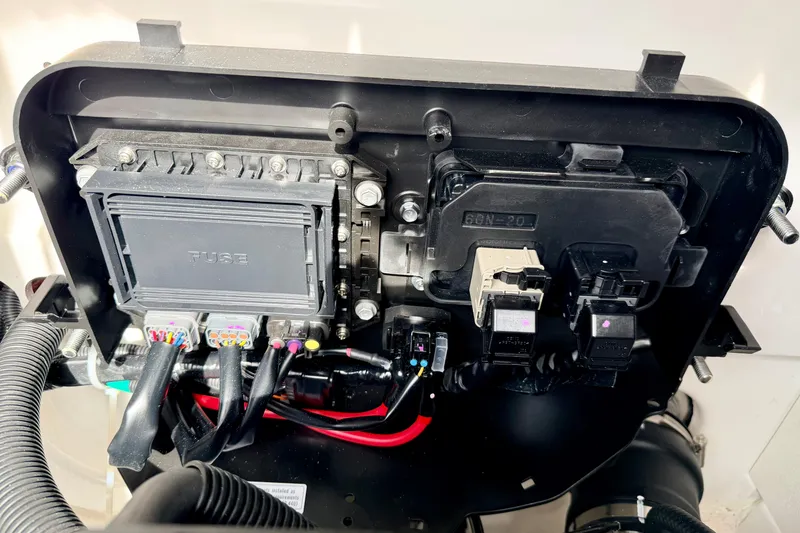 Slide: The Image of Electrical components inside a 2024 Yamaha AR195 boat, featuring wiring and fuse box. - 29