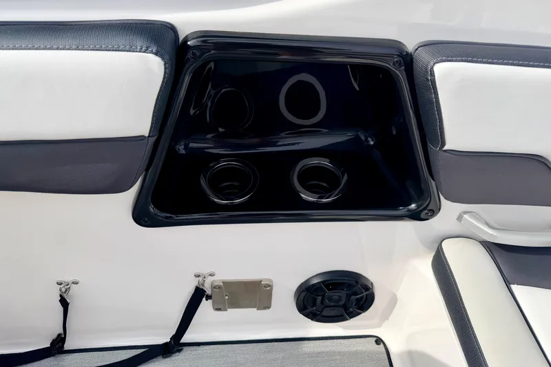 Slide: The Image of 2024 Yamaha AR195 boat interior with cup holders and speaker detail. - 32