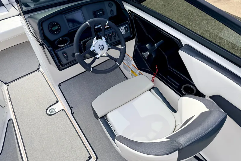 Slide: The Image of 2024 Yamaha AR195 boat cockpit with steering wheel and control panel. - 33
