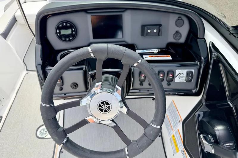 Slide: The Image of 2024 Yamaha AR195 boat dashboard with steering wheel and control panel. - 34