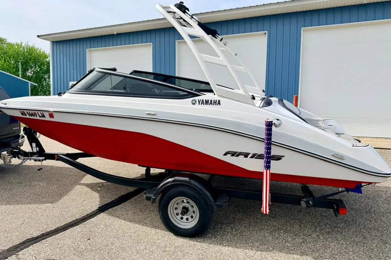 Slide: The Image of 2024 Yamaha AR195 boat with red and white design on a trailer. - 4