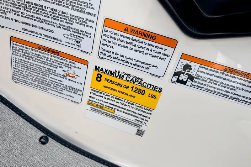 Slide: The Image of Warning labels on 2024 Yamaha AR195 boat, indicating maximum capacity of 8 persons or 1280 lbs. - 40