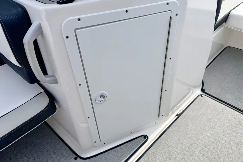Slide: The Image of 2024 Yamaha AR195 boat interior storage compartment with sleek design and handle. - 43
