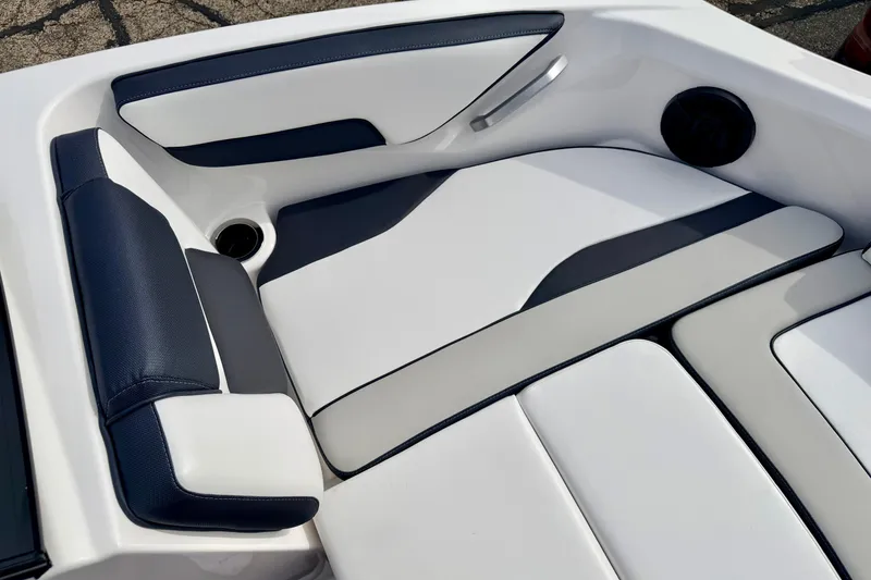 Slide: The Image of 2024 Yamaha AR195 boat interior with sleek white and navy seating design. - 50