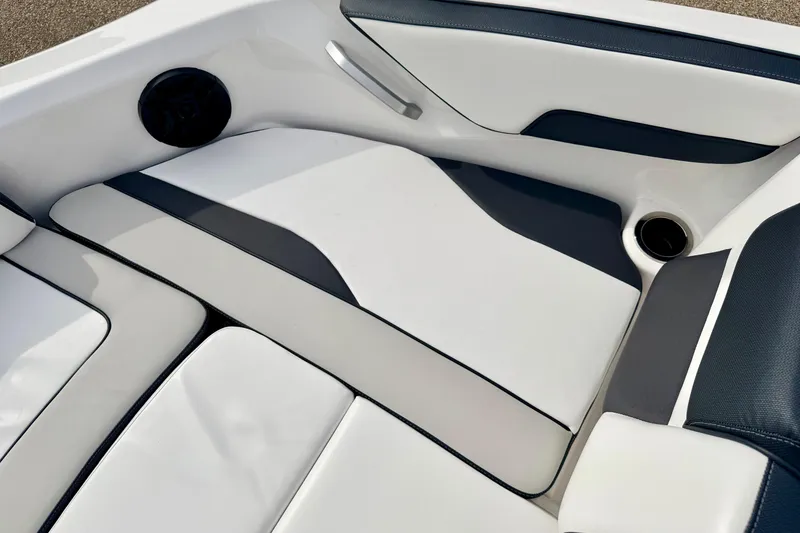 Slide: The Image of 2024 Yamaha AR195 boat interior with sleek white and gray seating design. - 52