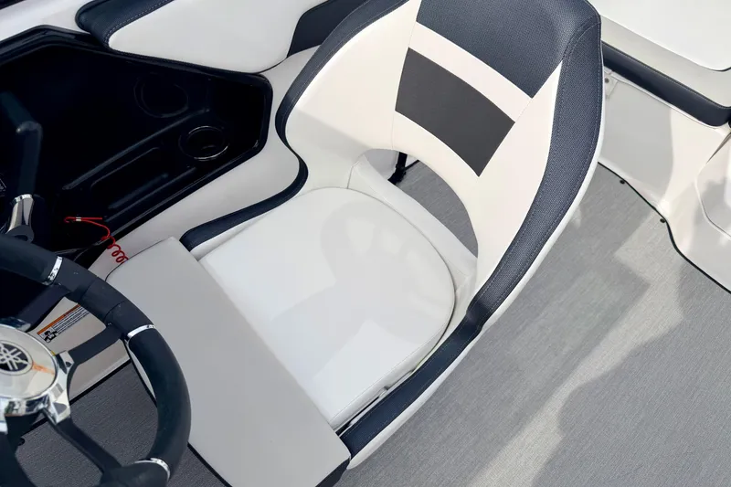 Slide: The Image of 2024 Yamaha AR195 boat interior with sleek steering wheel and modern seating design. - 61