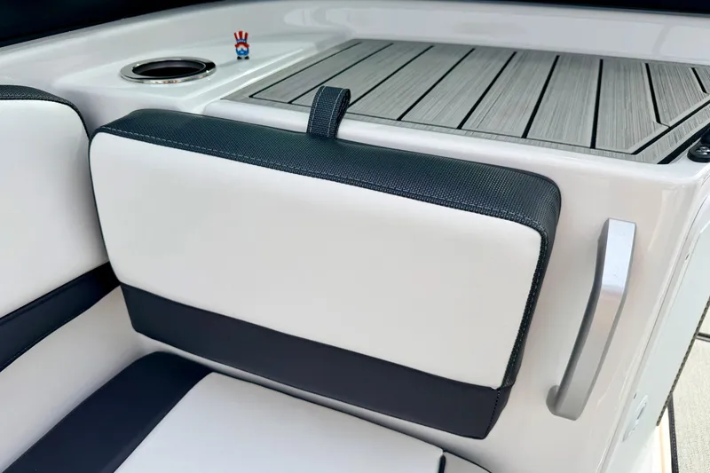 Slide: The Image of 2024 Yamaha AR195 boat interior with cushioned seating and cup holder. - 64