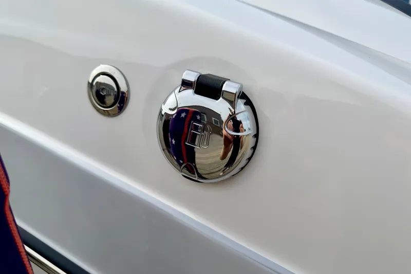 Slide: The Image of Chrome fuel cap on 2024 Yamaha AR195 boat, reflecting surroundings. - 67