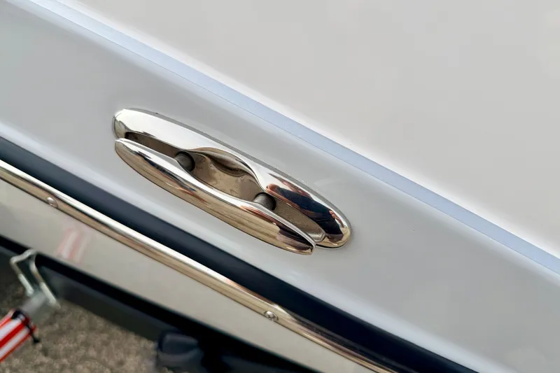 Slide: The Image of 2024 Yamaha AR195 boat cleat on white hull, close-up view. - 68