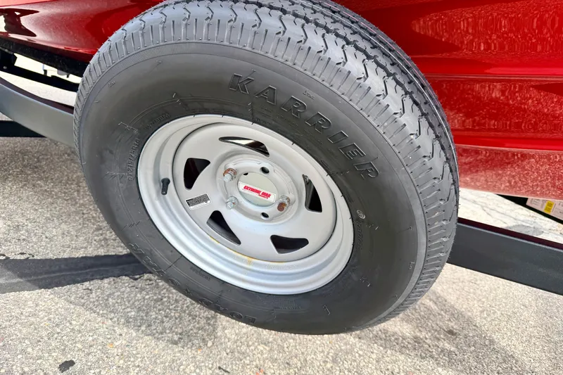 Slide: The Image of Close-up of a 2024 Yamaha AR195 trailer tire on a red boat trailer. - 70